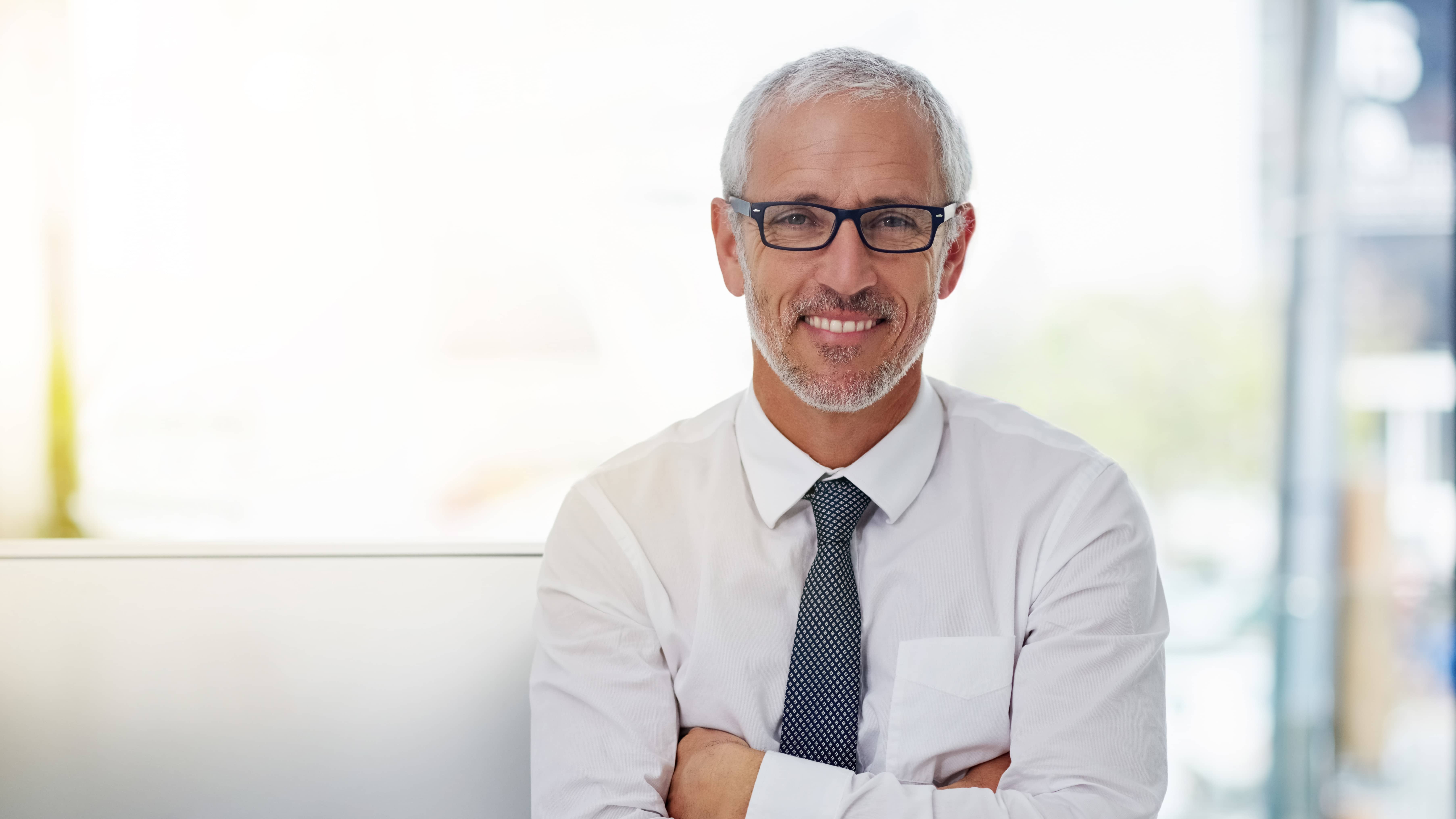 portrait-of-a-smiling-mature-businessman-standing-2026-03-25-02-54-50-utc (1)