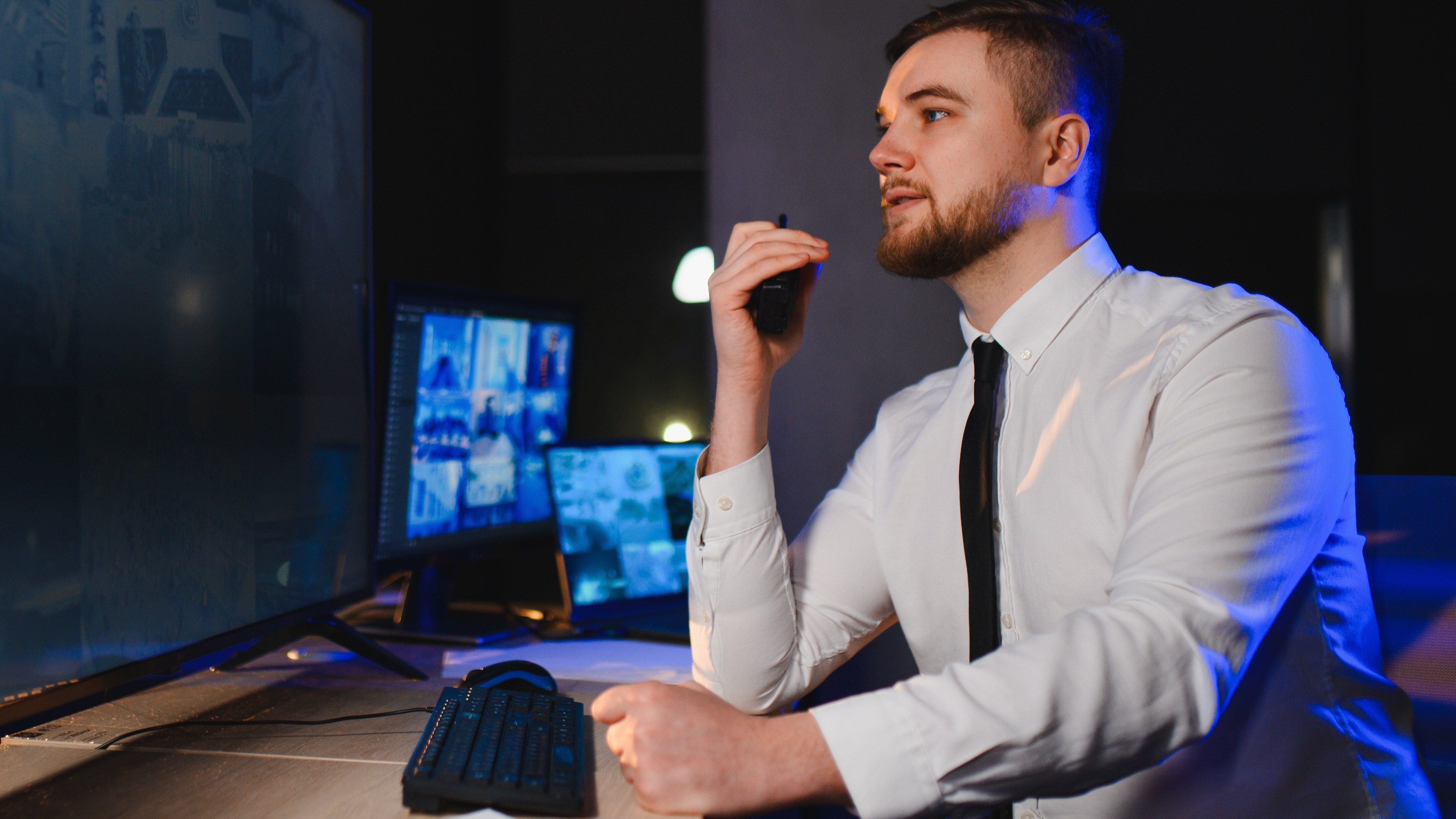 man-working-security-in-front-of-many-monitors-2026-03-11-01-03-45-utc