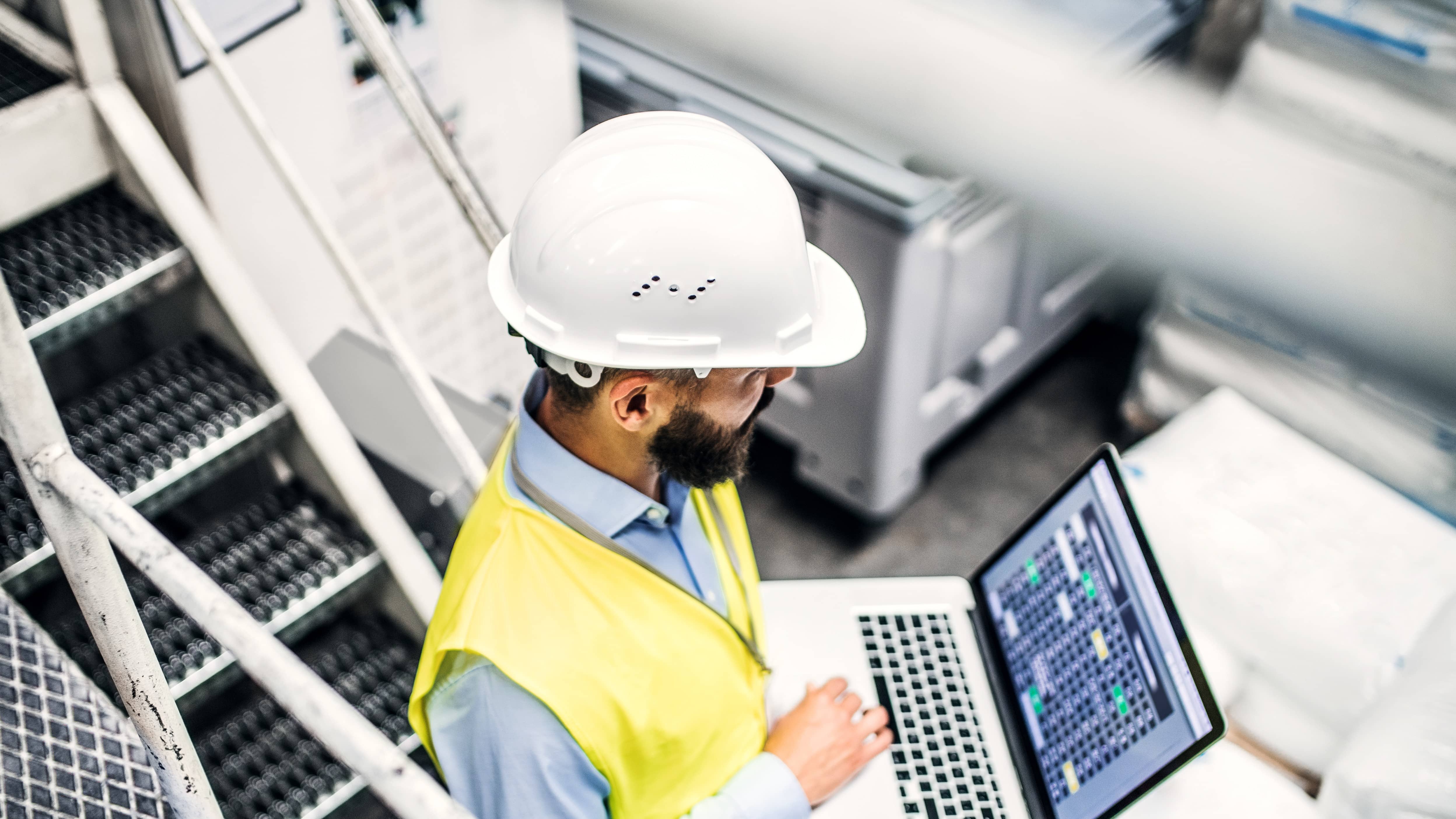  man inspecting infrastructure with laptop